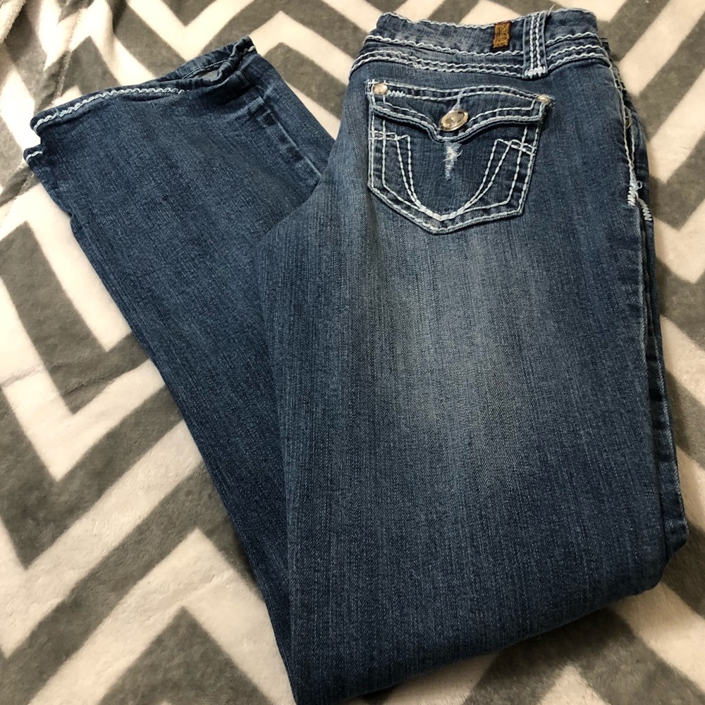 Ripped distressed jeans.